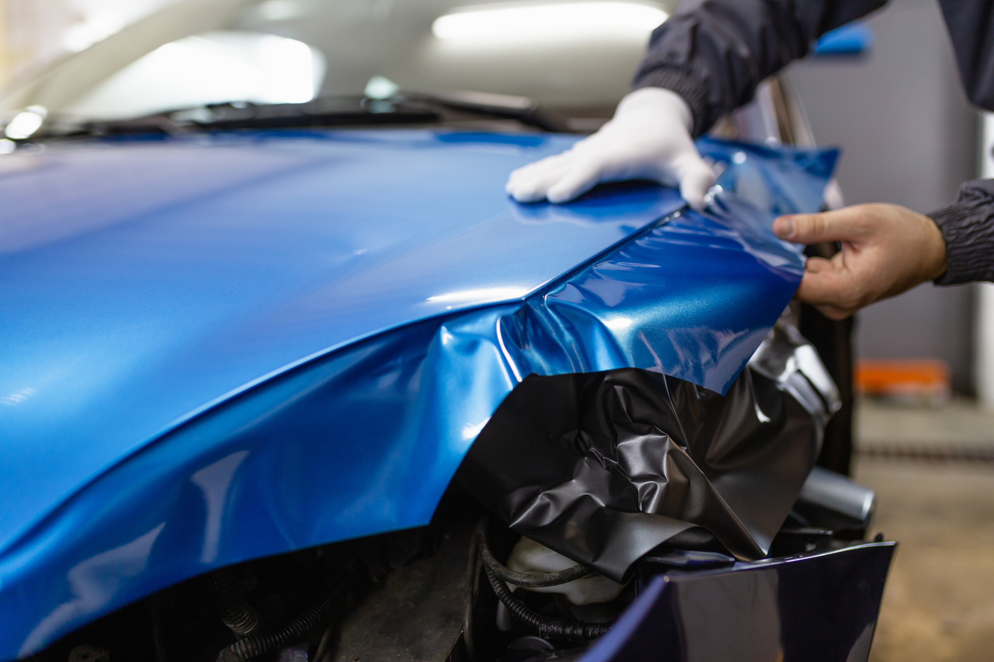 Matte black full vehicle vinyl wrap installation in progress